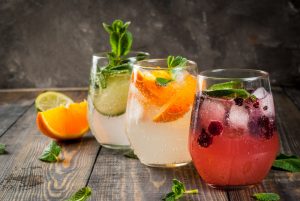 selection three kinds gin tonic with blackberries with orange with lime mint leaves glasses rustic wooden background